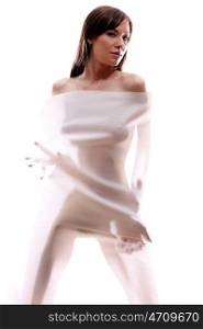 The body of a beautiful naked woman through the transparent fabric on a white background