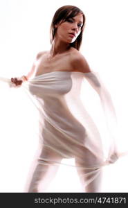 The body of a beautiful naked woman through the transparent fabric on a white background