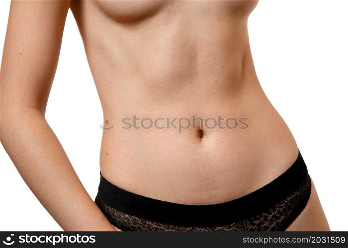 the body of a young beautiful nude girl with a good athletic body ,with a good abs on her stomach in black underwear on a white isolated background.