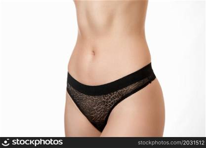 the body of a young beautiful nude girl with a good athletic body ,with a good abs on her stomach in black underwear on a white isolated background.