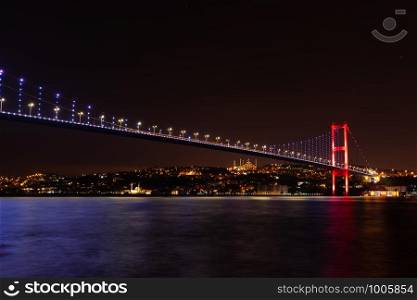 The Bosphorus Bridge or the 15 July Martyrs Bridge, view on the Asian side of night Istanbul, Turkey.. The Bosphorus Bridge or the 15 July Martyrs Bridge, view on the Asian side of night Istanbul, Turkey
