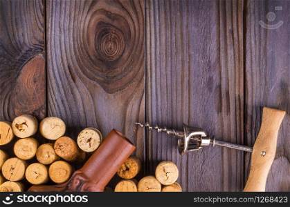 The bottle of wine with corks on wooden table background.