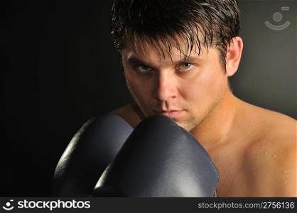 The boxer. The young man in boxing gloves