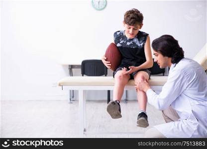 The boy american football player visiting young doctor traumatologis. Boy american football player visiting young doctor traumatologis