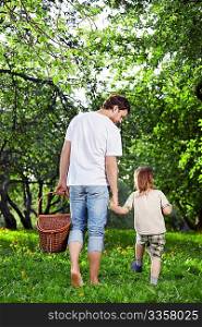 The boy and the daddy with a basket go in forest