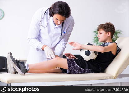 The boy football player visiting young doctor traumatologist. Boy football player visiting young doctor traumatologist