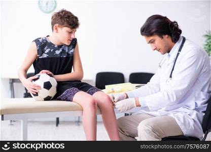 The boy football player visiting young doctor traumatologist. Boy football player visiting young doctor traumatologist