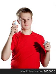 The boy, the teenager spraying fragrance perfume
