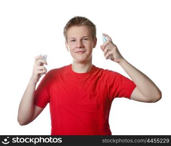 The boy, the teenager spraying fragrance perfume