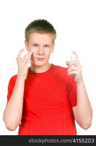 The boy, the teenager with a cream for a problem youthful skin, against spots