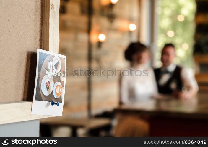 the bride and groom holding hands on the background of wooden wall photo frame