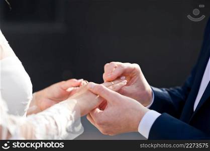 The bride and groom put wedding rings on their finger.. The process of putting wedding rings on the fingers of the newlyweds 42