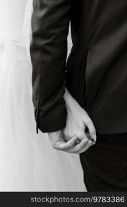 the bride and groom tenderly hold hands between them love and relationships