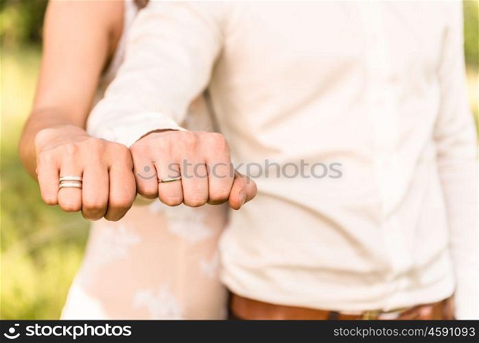 the bride and groom to hold hands, wedding rings