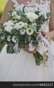 The bride is holding a wedding bouquet.. Delicate white-green wedding bouquet in the hands of the bride 2440.