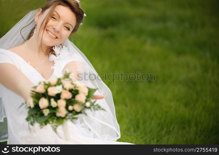 The bride on a lawn. The young girl in a wedding dress.