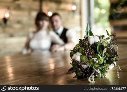the bride&rsquo;s bouquet from cones and cotton close up in natural light on a wooden table