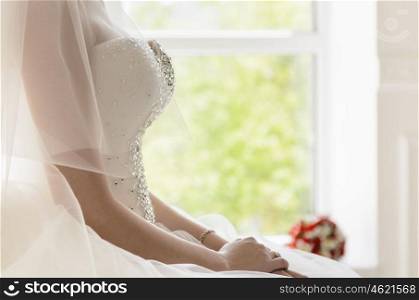 the bride sits on a vintage white chair