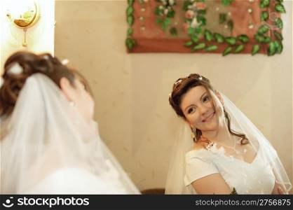 The bride. The young girl in a wedding dress on an abstract background