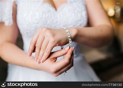 the bride wears a wedding bracelet on her left hand