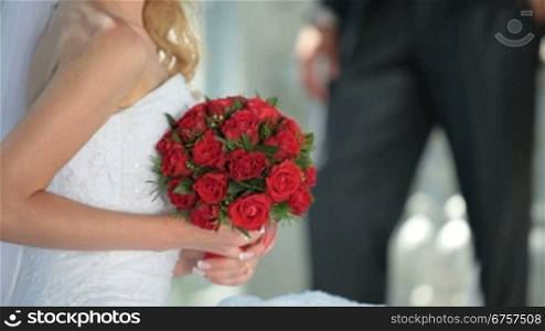 the bride with a wedding bouquet of red