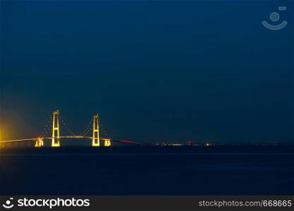 The bridge across the Great Belt - the Storebaelt Bridge in Denmark, night time.. Storebaelt Bridge in Denmark at night
