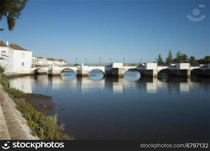 The Bridge Ponte Romana in the old town of Tavira at the east Algarve in the south of Portugal in Europe.. EUROPE PORTUGAL ALGARVE TAVIRA