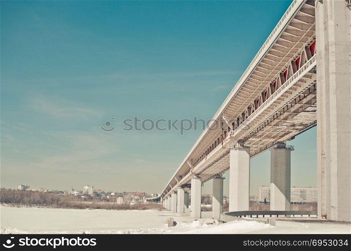 The bridge through Volga. The big long bridge on piles through the fr river.
