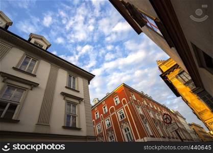 The bright, colorful facade of old house and sky at the Krakow, Poland