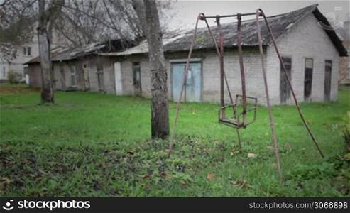 The broken child&acute;s swing. Unhappy childhood concept.