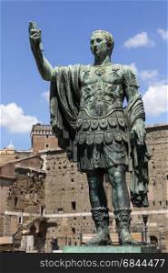 The bronze statue of Emperor Trajan near the ruins of Trajana??s Markets and the Roman Forum in the city of Rome in Italy. Statue of Trajan - Roman Forum - Rome - Italy