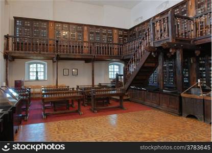 The building is an old library with tables and bookcases