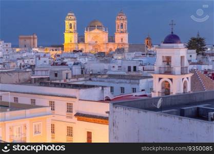 The building of the Cathedral of the Holy Cross in Cadiz against the blue sky at sunset. Spain. Andalusia.. Cathedral of the Holy Cross in Cadiz at sunset. Spain.