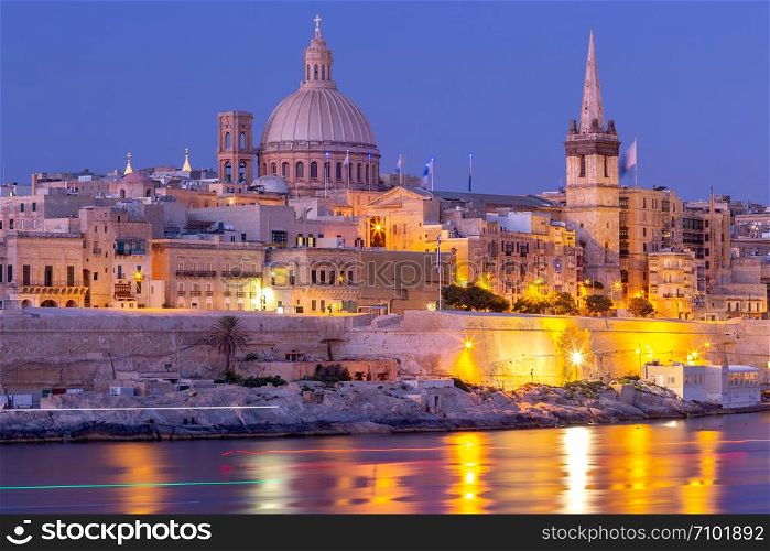 The building of the dome and bell tower of St. Paul&rsquo;s Cathedral in the night lighting. Valletta. Malta.. Valletta. The building of the Cathedral of St. Paul at sunset.