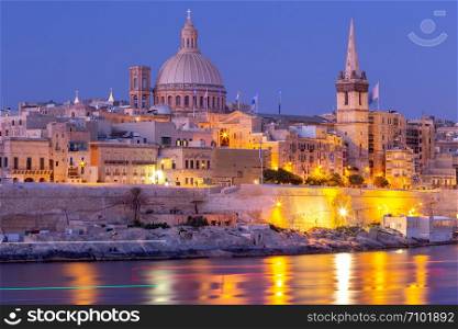 The building of the dome and bell tower of St. Paul&rsquo;s Cathedral in the night lighting. Valletta. Malta.. Valletta. The building of the Cathedral of St. Paul at sunset.
