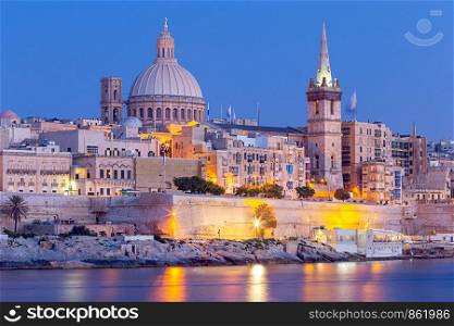 The building of the dome and bell tower of St. Paul's Cathedral in the night lighting. Valletta. Malta.. Valletta. The building of the Cathedral of St. Paul at sunset.