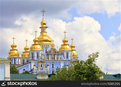 The building of the famous St. Michael?s Cathedral in Kyiv in the spring 05 12 2019 against the blue cloudy sky. The famous Golden-domed Michael?s Cathedral in Kyiv in the spring against the blue cloudy sky