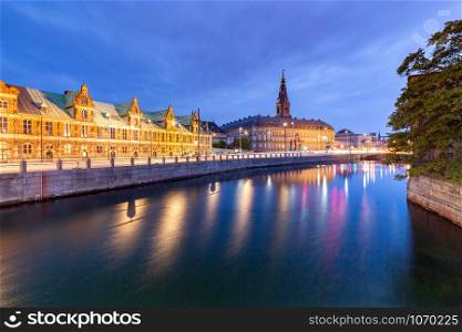 The building of the old city stock exchange on the embankment in the night illumination. Copenhagen. Denmark.. Copenhagen. Old City Exchange.