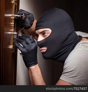 The burglar wearing balaclava mask at crime scene. Burglar wearing balaclava mask at crime scene