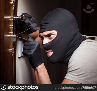 The burglar wearing balaclava mask at crime scene. Burglar wearing balaclava mask at crime scene