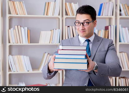 The business law student with pile of books working in library. Business law student with pile of books working in library