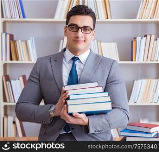 The business law student with pile of books working in library. Business law student with pile of books working in library