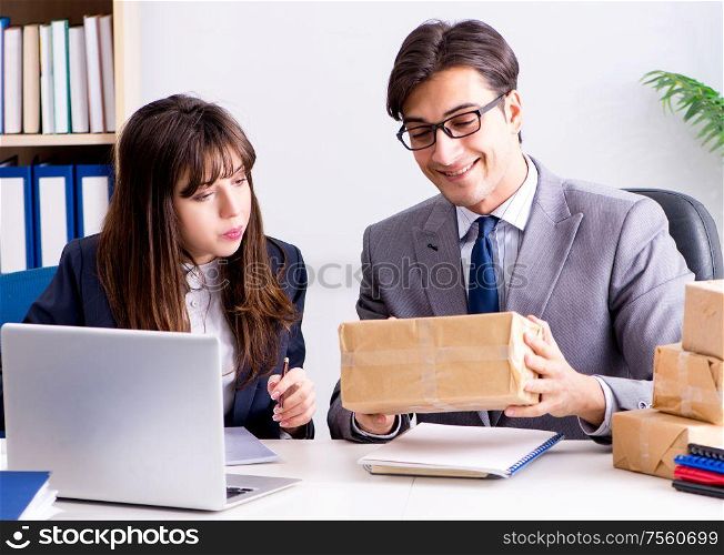The business people receiving new mail and parcels. Business people receiving new mail and parcels