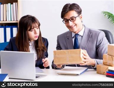 The business people receiving new mail and parcels. Business people receiving new mail and parcels