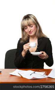 The business woman drinks coffee on the workplace. It is isolated on the white background.