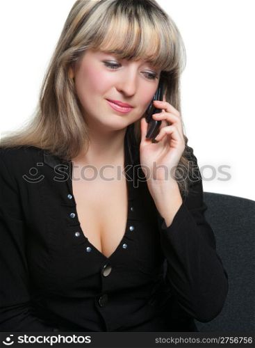 The business woman on the workplace talks by the mobile phone. It is isolated on the white background.