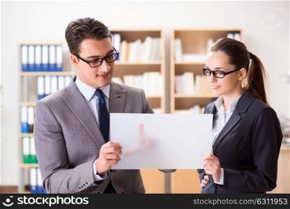 The businessman and businesswoman having discussion in office. Businessman and businesswoman having discussion in office