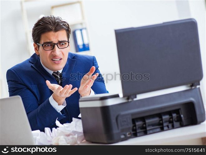 The businessman angry at copying machine jamming papers. Businessman angry at copying machine jamming papers