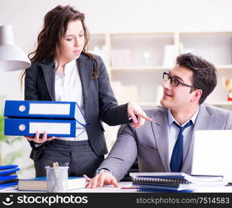 The businessman asking for paperwork from his assistant secretary. Businessman asking for paperwork from his assistant secretary