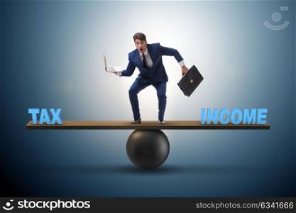 The businessman balancing between income and tax in business concept. Businessman balancing between income and tax in business concept